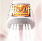 White electronic device with glowing orange interior on a light pink background