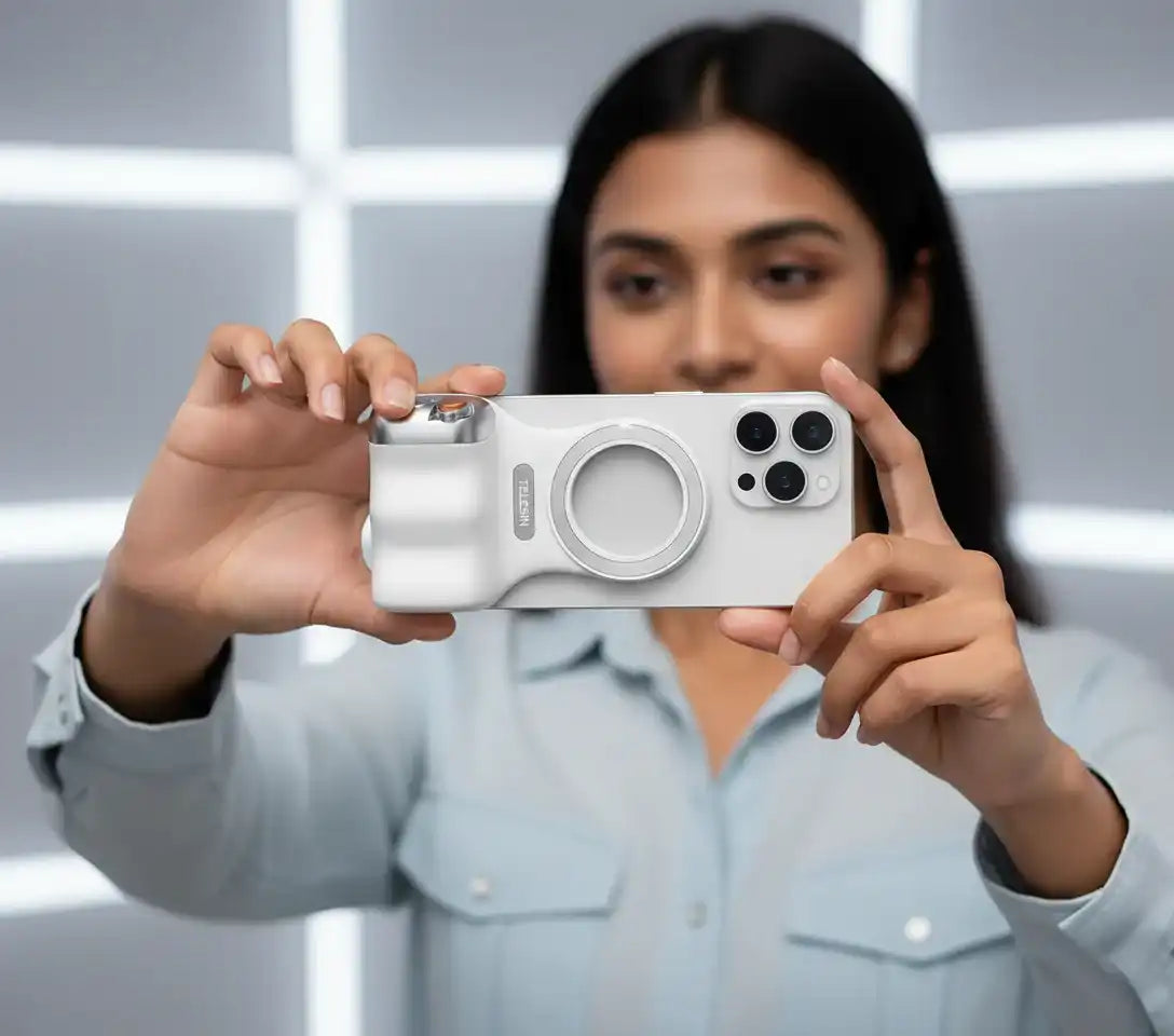 Person holding a white phone case with multiple camera lenses against a blurred background